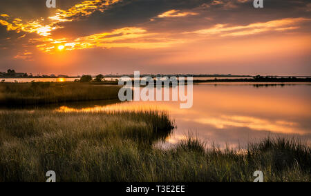 The sun sets over the Mississippi Sound on New Year's Day in Dauphin Island, Alabama. Stock Photo