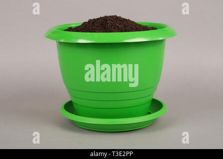 Green Plastic Flower Pots on Grey Background Stock Photo