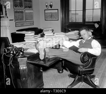1/26/1938 - Democrat Senator Allen J. Ellender, of Louisiana, rests and studies up on Senate procedure of filibuster while his colleagues continue the Filibuster against the anti-lynching bill ca. 1938 Stock Photo