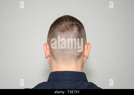 Back view portrait of a bearded middle aged man in stylish dark shirt with short modern haircut Stock Photo