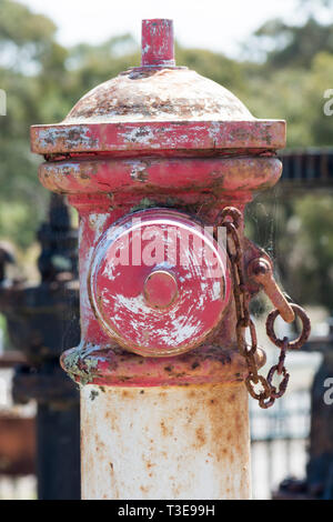 The upper portion of an old red decommissioned fire hydrant in close up. Stock Photo