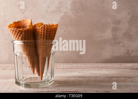 Closeup of three waffle ice cream cones in a large glass, with copy space. Stock Photo