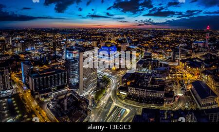 Birmingham, UK aerial from drone at sunset - night. Includes library, Town Hall, BT Tower and skyline.