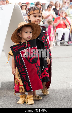 Native American children wearing traditional clothing at the Penn Cove Water Festival. Pacific Northwest Haida Tlingit Indian tribes. Stock Photo