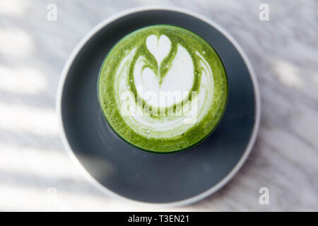 Matcha colorful super latte on marble table in grey plate. Trendy detox healthy drink Stock Photo