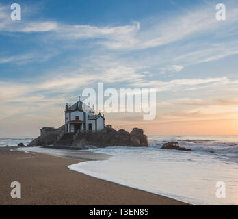 Sunset by the Chapel on the beach near Miramar, Oporto, Portugal Stock Photo