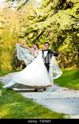 Wedding couple dancing in the park Stock Photo - Alamy