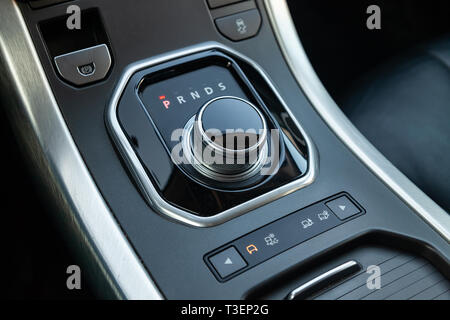 Gearbox gearbox selector in the form of a retractable washer in the center console of the instrument panel Stock Photo