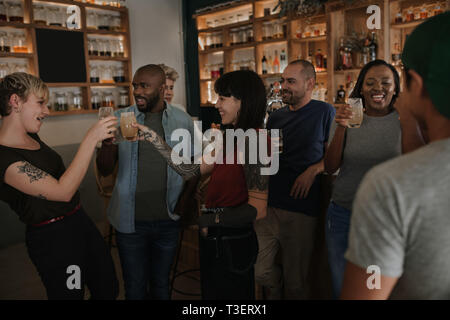 Diverse young friends having fun together in a bar Stock Photo