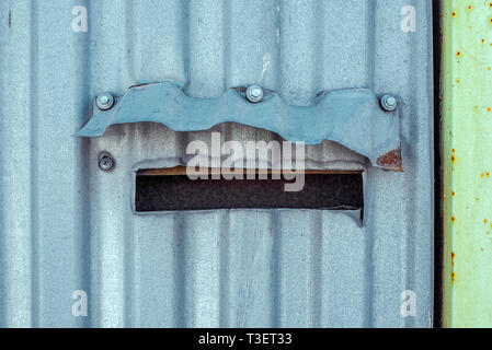 Mail box With Cap On Corrugated Iron on Fence. Horizontal texture of scratch paint on steel Stock Photo