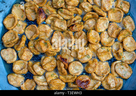 Heap of fried soy tortillas with vegetables in local street market in Thailand, close up. Thai food Stock Photo