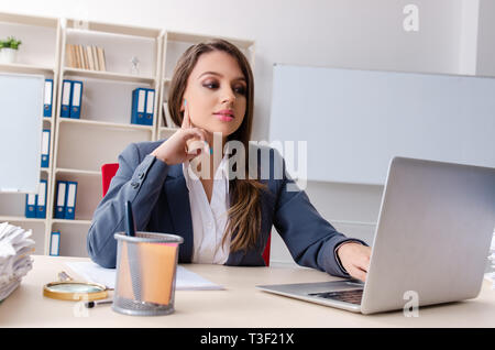 Beautiful female employee unhappy with excessive work Stock Photo