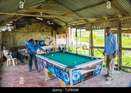 Dunga fishing village, near Kisumu, Kenya - March 8th, 2019 - men playing snooker Stock Photo