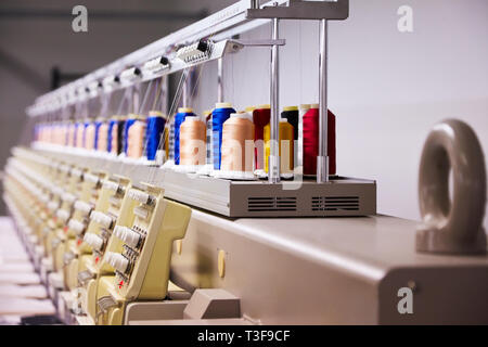 Automatic Embroidery Machines in process on the factory. 9 Needle Compact Embroidery Machine. Stock Photo