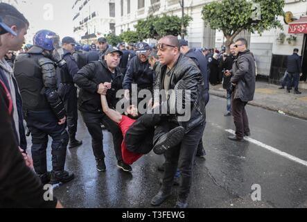 Algiers, Algeria. 09th Apr, 2019. Algerian security forces arrest a protesting student during an anti-government demonstraion. The Algerian parliament declared the vacancy of the president's post and named speaker Abdelkader Bensalah to lead Algeria for a transitional period of 90 days untill the election of the successor of the resigned president Abdelaziz Bouteflika. Credit: Farouk Batiche/dpa/Alamy Live News Stock Photo