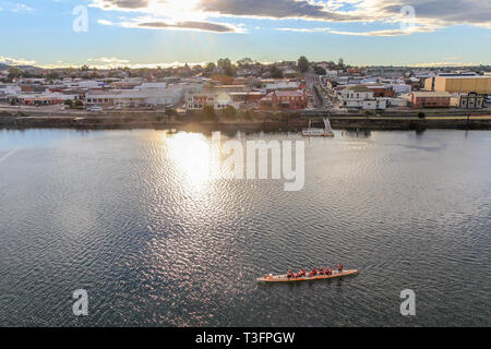 Sunset in tasmanian town Devonport with Mersey river and canoe in the foreground, Tasmania Stock Photo