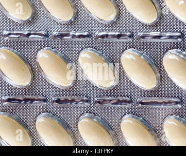 Packaged in blisters convex tablets drugs, closeup Stock Photo