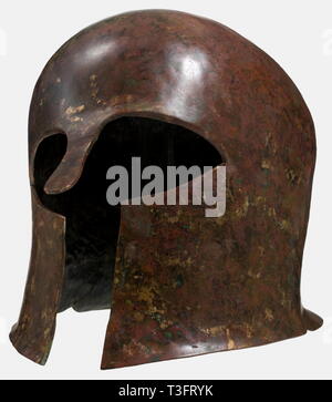 A Corinthian helmet, 7th - 6th century B.C. Bronze helmet with a heavy skull, large eye cutouts, a protruding, strong nasal, short neck guard, and small cutouts on the sides. Height 23.5 cm. Weight 1340 g. Reddish-brown patina, metallic surface in places. Restorations in the skull. The interior stabilised with fibreglass. Axel Guttmann Collection (no inventory number) acquired at Krefeld in 1996. Cf. a similar helmet from the Guttmann Collection in Hermann Historica. 54th auction, 11 April 2008, lot 314. Beautiful, early archaic Greek helmet with, Additional-Rights-Clearance-Info-Not-Available Stock Photo