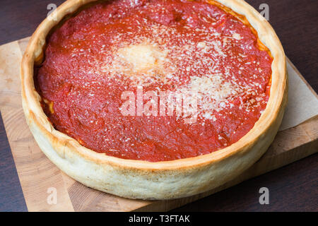 Top view of Chicago pizza. Chicago style deep dish italian cheese pizza with tomato sauce Stock Photo