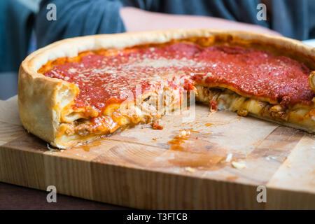 Top view of Chicago pizza. Chicago style deep dish italian cheese pizza with tomato sauce and beef meet inside Stock Photo