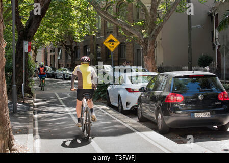 Cyclists using a dedicated bike or bicycle lane in the Sydney suburb of Surry Hillls, NSW, Australia