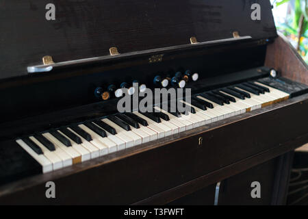 Old and dusty piano keyboard. Black and white key board on vintage musical instrument Stock Photo