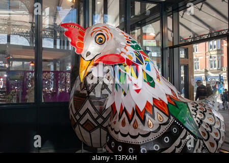 Preston, Lancashire. UK 9th April 2019. Giant Easter chickens on display in the city centre. Papier-Mache giant cockerel Easter festive figures on display. Standing at two-metres tall, the attractions are to be placed outside Preston Market. Keith Ogden, a local artist, is the man behind the hand painted attraction. The eggs are themed around the the city's industrial heritage and Lancashire landscapes. Preston Markets are to exhibit the Giant Easter Eggs for selfie competition over the Easter holidays. Stock Photo