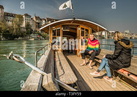 Jacques Thurneysen, born in Paris and at home on the Rhine: for many decades he has held the lease for the small cable ferry, which is connected via the Schwengel to a wire cable that links Basel Cathedral with the other bank. At the age of 65, Thurneysen hands over the lease to his son Noa. During the summer, the ferry is in service 77 hours a week. Jacques Thurneysen shares the shifts with his son and nephew. Leu Ferry at the Cathedral in Basel, Switzerland Stock Photo