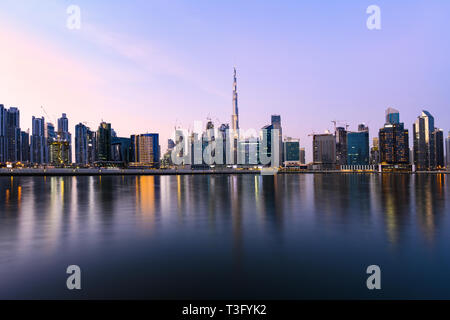 Stunning panoramic view of the Dubai skyline during sunset with the magnificent Burj Khalifa and many other buildings and skyscrapers. Dubai, UEA. Stock Photo