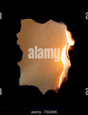 burning piece of  paper on black background Stock Photo