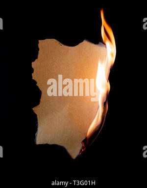 burning piece of  paper on black background Stock Photo