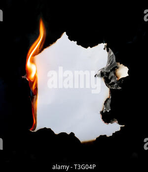 burning piece of  paper on black background Stock Photo