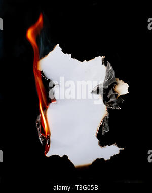 burning piece of  paper on black background Stock Photo