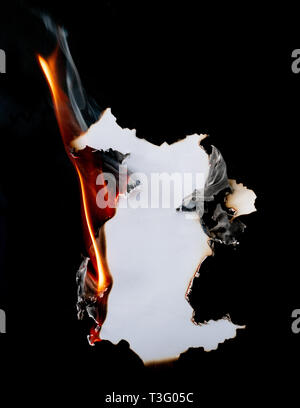 burning piece of  paper on black background Stock Photo
