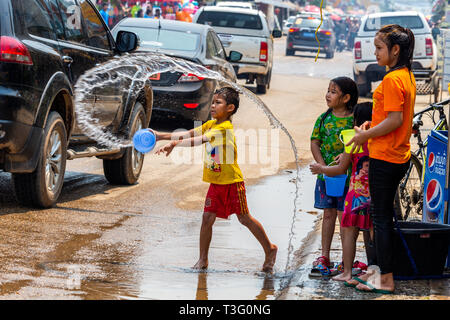 Vang Vieng, Laos - April 14, 2018: Kids throwing water on the streets of Vang Vieng during the Lao New Year celebrations Stock Photo