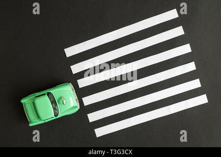 Overhead view of small car and pedestrian pathway on a street crossing abstract. Stock Photo