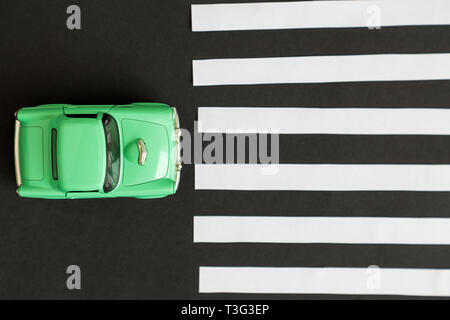 Flat lay of car toy on pedestrian crossing minimal creative concept. Stock Photo