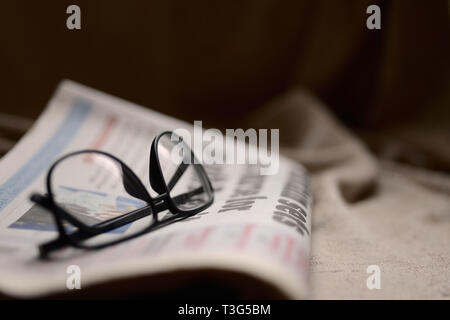 Glasses on top of a newspaper with copyspace Stock Photo
