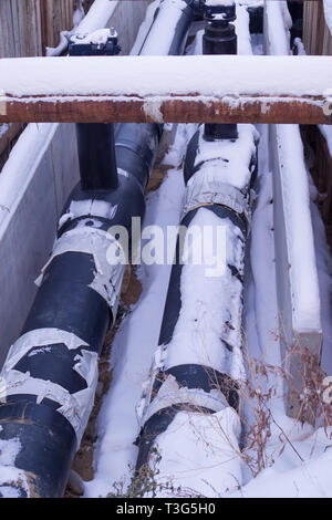 industrial pipelines covered in snow. construction, transportation. Stock Photo