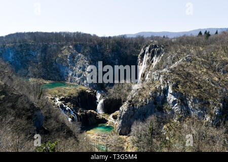 Lakes and waterfalls of Plitvice Lakes National Park in Croatia during early spring. Deep view of lakes and waterfalls surrounded by cliffs and trees Stock Photo