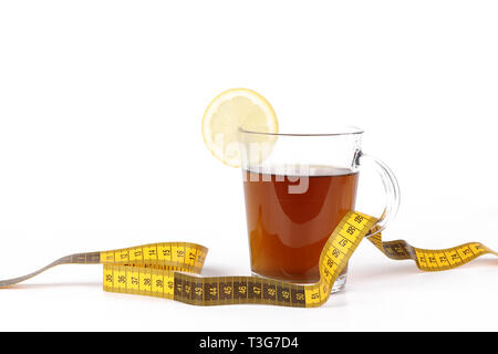 Slimming tea, cup with tea with lemon and measuring tape isolated on white background Stock Photo