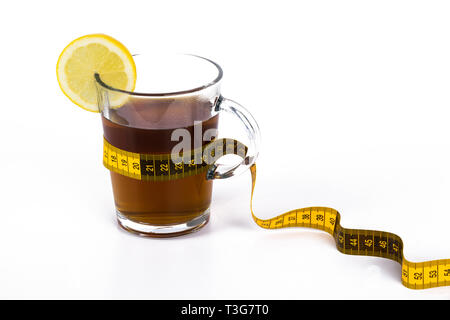 Slimming tea, cup with tea with lemon and measuring tape isolated on white background Stock Photo