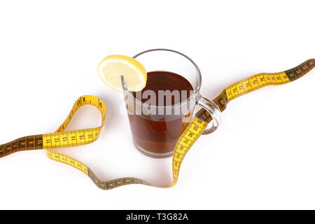 Slimming tea, cup with tea with lemon and measuring tape isolated on white background Stock Photo
