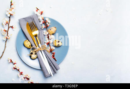 Easter Table Setting with Quail Eggs and Branches in Blossom, Spring Holidays Bright Background Stock Photo