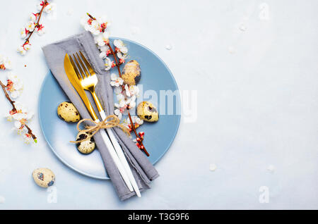 Easter Table Setting with Quail Eggs and Branches in Blossom, Spring Holidays Bright Background Stock Photo