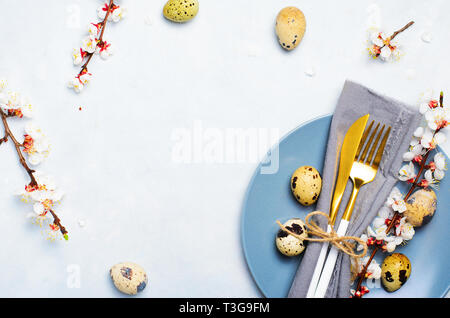 Easter Table Setting with Quail Eggs and Branches in Blossom, Spring Holidays Bright Background Stock Photo