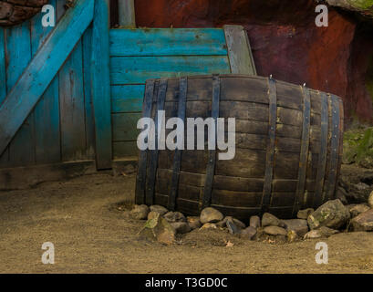 vintage wooden barrel in the sand, Decor in wild west style Stock Photo