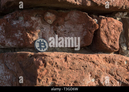 Made from black plastic custom bit coin in nature Stock Photo