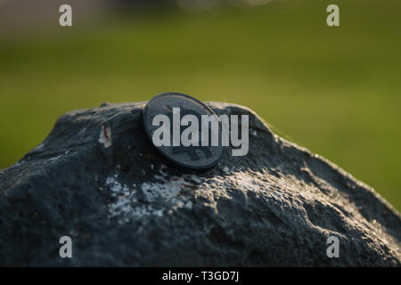Made from black plastic custom bit coin on rustic old background Stock Photo