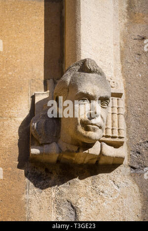 A carved stone face or head on the wall of the Old Schools Quadrangle at the Bodleian Library, Oxford Stock Photo